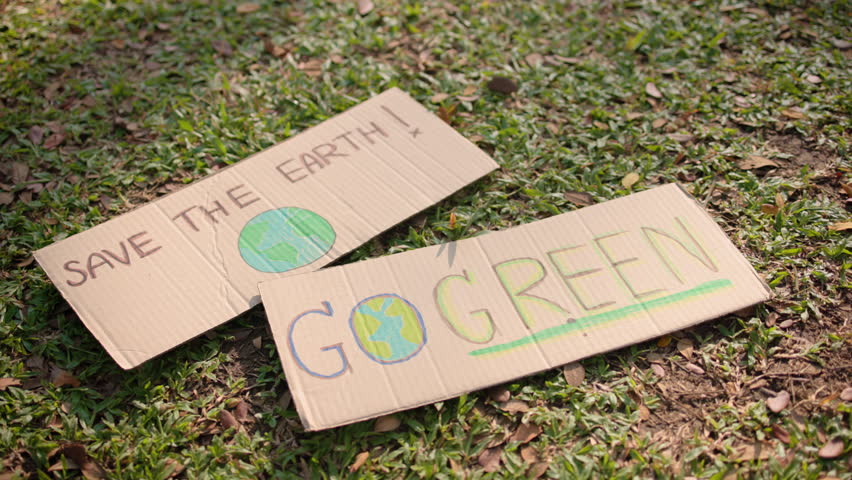 Go green no people save the earth planet world care banner poster sign showing on meadow grass floor in city nature sun light. Plastic free issues Protect future hope net zero waste the way forward. Royalty-Free Stock Footage #3480672567