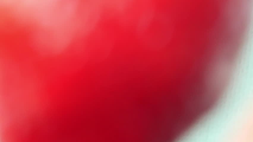 Strawberries dramatically plunge into water in high-angle view, creating captivating ripples. Strawberries