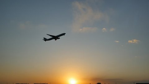 Plane taking off sky sunset sun dusk in airport.