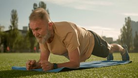 Caucasian old man in plank exercise workout training stadium city outside effort strain fitness athlete health muscular physical pose bodybuilder strong endurance power sporty determination practicing - Powered by Shutterstock - Get 15% off with code: PIKWIZARD15
