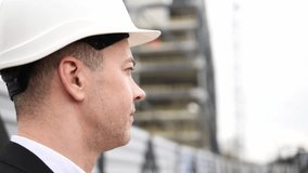Close-up young male architect in white helmet business suit carefully studying the project plan architect demonstrates concentration, quintessence of architectural precision and experience in design. - Powered by Shutterstock - Get 15% off with code: PIKWIZARD15