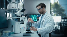 Pharmaceutical Laboratory: Young Male Scientist Working with Samples, Using Micro Pipette for Mixing Chemicals and Acids. Advanced Scientific Specialist Working with Modern Digital Microscope - Powered by Shutterstock - Get 15% off with code: PIKWIZARD15