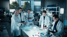 PhD Professor Teaching a Group of Science Students the Basics of Gene Therapy and Biological Engineering. Head of Laboratory Creating Conditions for Practical Education and Technology Demonstration - Powered by Shutterstock - Get 15% off with code: PIKWIZARD15