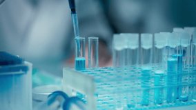 Person Taking a Sample with a Micro Pipette and Dropping the Blue Liquid into a Petri Dish. Close Up of Anonymous Scientists Conducting Medical Research and Discovery in Science Lab - Powered by Shutterstock - Get 15% off with code: PIKWIZARD15