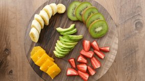 Top view of fruits on a rotating wooden plate