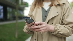 Close up young businesswoman student worker holding mobile phone in hands texting message in web chat surfing corporate network reading news. Millennial female work online using smartphone outdoors - Powered by Shutterstock - Get 15% off with code: PIKWIZARD15