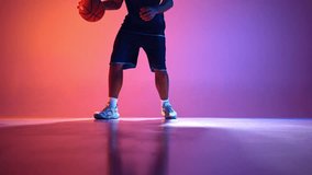 Power and control. Man, basketball player in motion, action, dribbling ball with accuracy on gradient red purple background in neon light. Concept of professional sport, competition, game, action