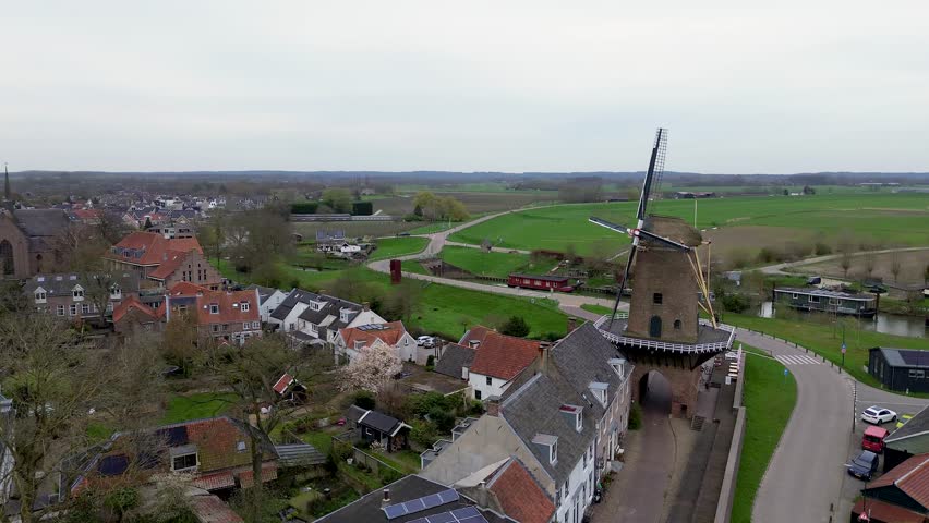 Beautiful view from above, from drone to orange, tiled roofs of houses. Top view of the Dutch city of Wijk bij Duurstede. The streets and roof of the church. Central Square of the city.