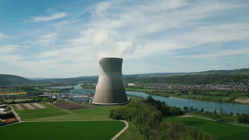 Nuclear power plant with river on background. Atomic power plant with cooling tower, South Germany. Environmental conservation concept
