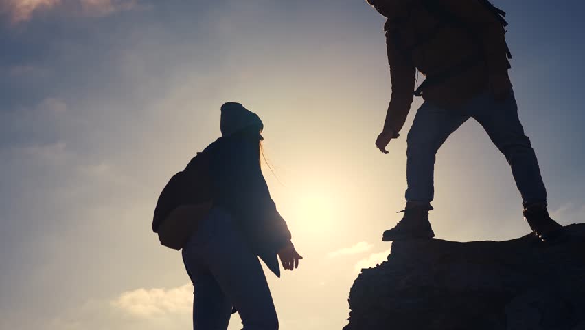 business. teamwork helps hand down business silhouette concept. a group of tourists lend a helping hand, climbing rocks, mountains, lend helping hand. teamwork people climbers travel climb to top Royalty-Free Stock Footage #3481121559