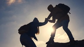 business. teamwork helps hand down business silhouette concept. a group of tourists lend a helping hand, climbing rocks, mountains, lend helping hand. teamwork people climbers travel climb to top - Powered by Shutterstock - Get 15% off with code: PIKWIZARD15