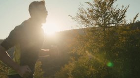 Side view athletic bearded adult Caucasian male climber man sport guy sportsman mountaineer running training run workout exercise travelling recreation outside beautiful sunny mountainside nature hill - Powered by Shutterstock - Get 15% off with code: PIKWIZARD15