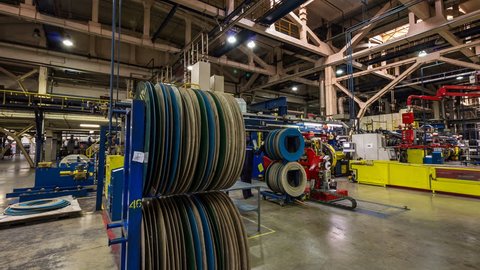 time lapse skilled employees work with modern industrial equipment producing rubber tires for wheels in plant