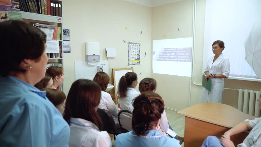 The head physician conducts a lecture in the clinic's office. The medical staff is instructed. Royalty-Free Stock Footage #34812061