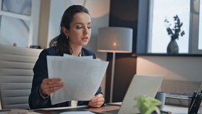 Serious employee reading papers deal in office closeup. Tired businesswoman looking documents checking contract conditions. Young manager closed laptop lid feeling disappointed. Ceo thinking strategy - Powered by Shutterstock - Get 15% off with code: PIKWIZARD15
