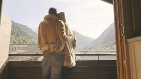 Happy couple at autumn mountains talking, hugging and drinking tea on terrace with beautiful view - Powered by Shutterstock - Get 15% off with code: PIKWIZARD15