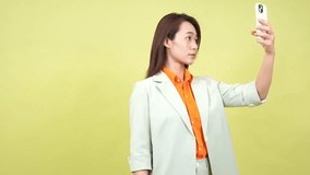 Young Asian businesswoman on green background