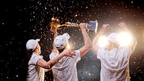 Team of four young winners together celebrates success and jump for joy, raising arms and victory trophy up. Happy award, triumph achievement in sport competition - Powered by Shutterstock - Get 15% off with code: PIKWIZARD15