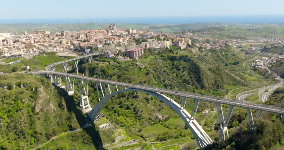 Aerial view of the historic center of Catanzaro and the famous access bridge to the city. It is the capital of Calabria, southern Italy. In the background is the Ionian Sea.