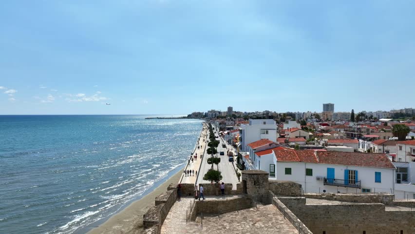 Larnaca , Cyprus. Aerial view of the beach and coastline in Larnaca city ,Cyprus. Beautiful promenade full with people on a sunny day.