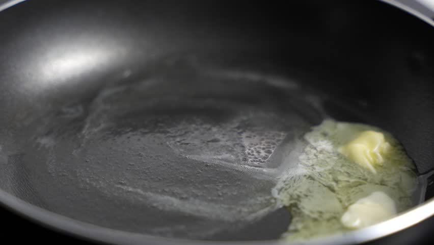 Butter melts in a hot frying pan. Butter in a frying pan.