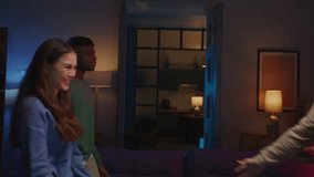 Excited people meeting in stylish apartment and hugging with glad expression after long time separation. Curly guy spinning asian female by hand and laughing while celebrating meeting. - Powered by Shutterstock - Get 15% off with code: PIKWIZARD15