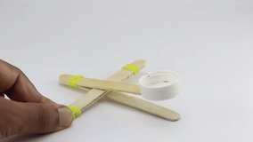 Mini catapult model made using ice cream stick and uses elastic band