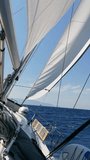Sailing yacht on a sunny summer day at sea.  POV. Vertical Video