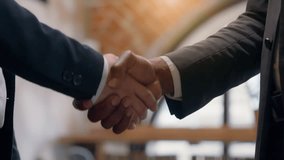 Two male hands shaking greeting welcome gesture congratulation conclude agreement partnership cooperation teamwork multiracial men business colleagues coworkers businessmen handshaking in office deal - Powered by Shutterstock - Get 15% off with code: PIKWIZARD15