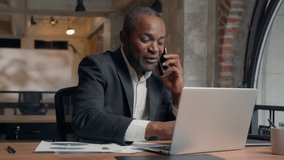 Multitasking busy African American entrepreneur with laptop computer paperwork check data in papers business man office businessman male guy executive talking mobile phone smartphone call conversation - Powered by Shutterstock - Get 15% off with code: PIKWIZARD15
