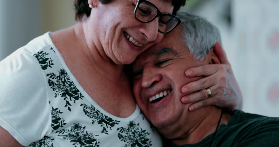 Happy senior couple's embrace and love. Elderly spouse kissing and hugging husband in loving manner, authentic joyful old age relationship, genuine partners in old age