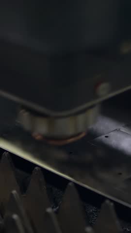 Industrial laser cutting of sheet metal with sparks on iron factory