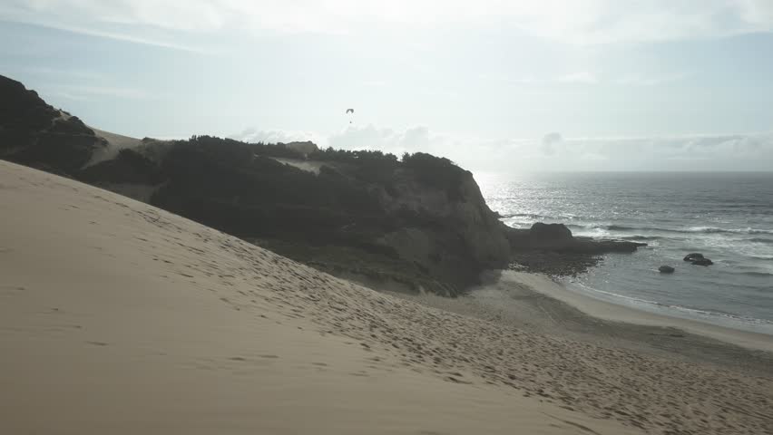 Paraglider Paragliding Over Cape Kiwanda In Oregon Coast, USA. - aerial shot