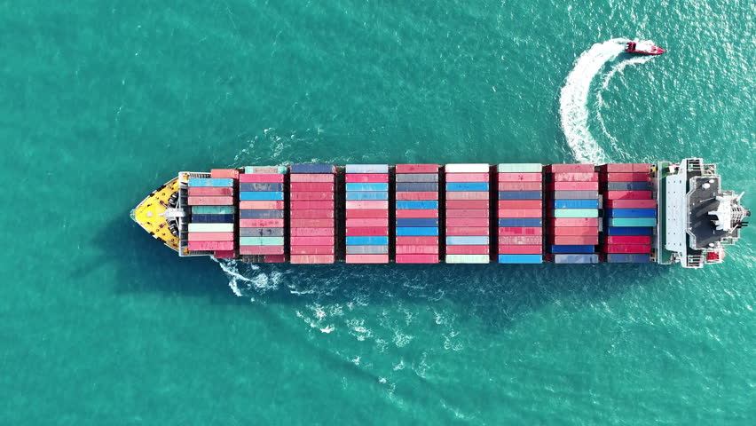 Cargo Container Ship with Pilot Boat running in the ocean. Container ship carrying container import export concept technology freight shipping by ship. aerial top of express Container Vessel