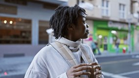 African american woman with dreadlocks wearing a beige sweater enjoys a moment on a lively urban city street.