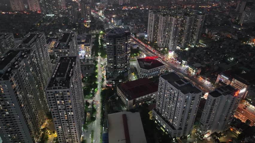 Aerial drone skyline view of Hanoi cityscape at night in Minh Khai street
