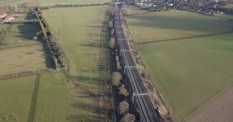 4k aerial footage fast high speed train on railway track beautiful countryside landscape in Berkshire, UK