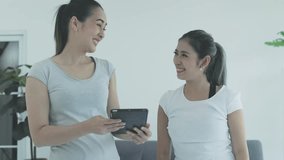 two asian women using digital tablet learning exercise online