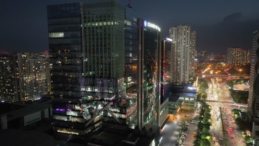 Aerial drone skyline video of Hanoi cityscape at night in Tran Duy Hung street