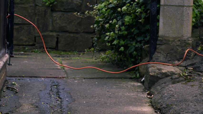 Woman trips over cable on pathway medium zoom shot slow motion selective focus