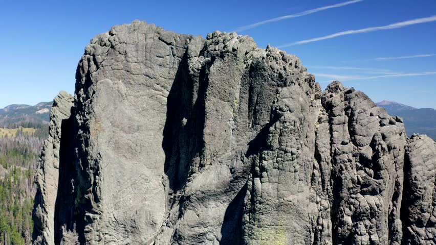 A rocky cliff with a grayish color. The cliff is an ancient volcanic core known as Rabbit Ears in Southern Oregon.