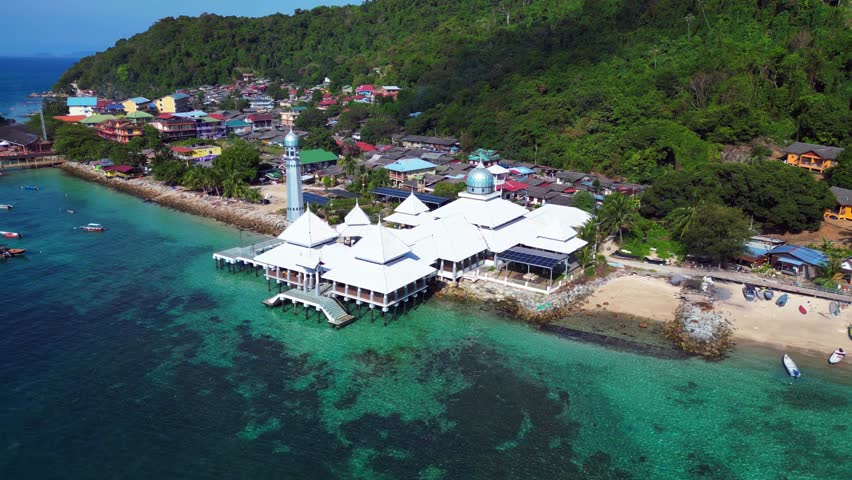 Islamic white mosque at beach on Perhentian Island. Amazing aerial top view flight panorama orbit drone
4k