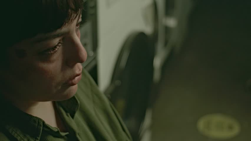 Crying Woman, Brooding Atmosphere, Poignant Mood of Young Latina Woman in Laundry, Close Up