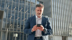 Successful mature hispanic senior business man using smartphone cellphone financial application. Indian or latin confident middle age male entrepreneur businessman holding mobile cell phone for invest - Powered by Shutterstock - Get 15% off with code: PIKWIZARD15