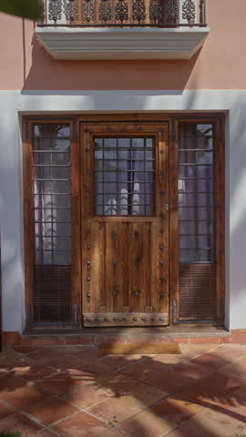 Traditional wooden door with iron details on a colonial house in mexico, exemplifying rustic architecture.