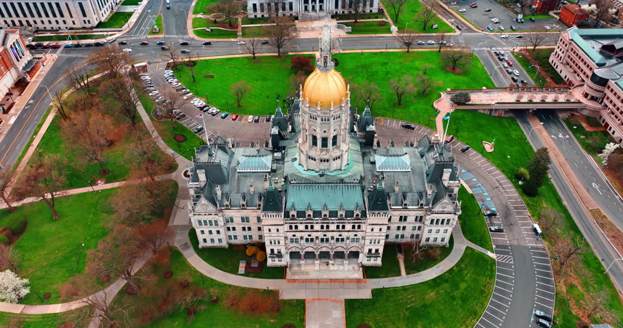 Distancing from the Connecticut State Capitol in Hartford, Connecticut, the USA. Green lawns are around the building and asphalt roads. Top view.