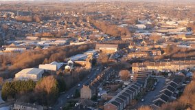 Aerial video footage of industrial buildings and housing. Terraced streets in textile towns at sunset. Chemical Plant surrounded by red brick homes with busy streets. Yorkshire living concept