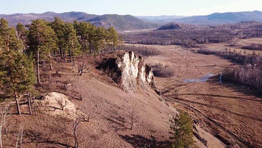Panoramic view of autumn mountains with trees and geological camp in Siberia. Geologist trailer park