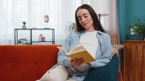 Pregnant Caucasian woman lady reading book feeling relax on cozy sofa couch at home. Future mother beautiful female read advice child care guide prepare prenatal. Relaxation and pregnancy concept. - Powered by Shutterstock - Get 15% off with code: PIKWIZARD15