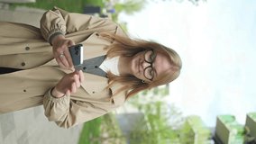 Close up young businesswoman student worker holding mobile phone in hands texting message in web chat surfing corporate network reading news. Millennial female work online using smartphone outdoors - Powered by Shutterstock - Get 15% off with code: PIKWIZARD15